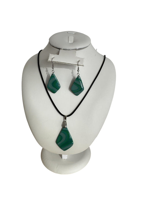 Jewelry set with necklace and earrings on a mannequin bust against a white background